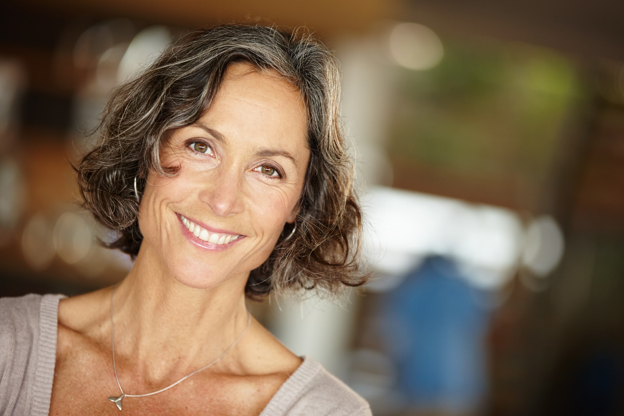 Smiling woman in her fifties, relaxed and confident after dental treatment abroad
